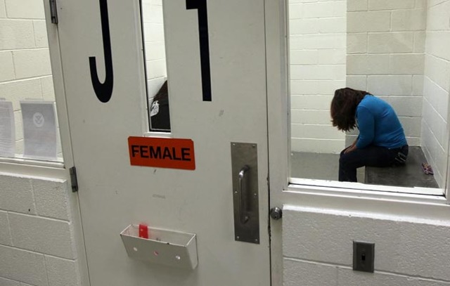 A woman being held at an ICE detention facility. Photo: Getty Images/John Moore 